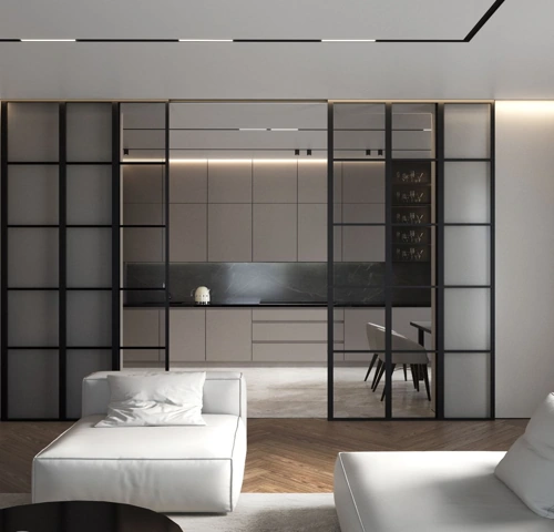 Modern black-framed glass sliding doors separating a minimalist living area from a sleek kitchen.
