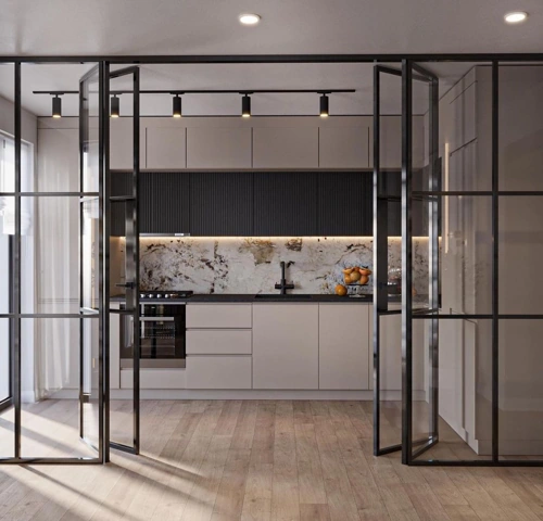 Modern kitchen with beige cabinets and a marble backsplash, viewed through open black-framed glass doors.